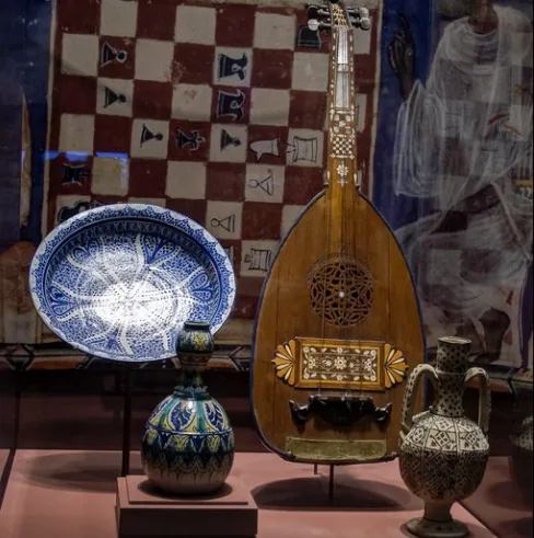 African chess board, stringed musical instrument, and ceramics